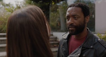 Movie still from “Locked Down” (2021), directed by Doug Liman – A man and a woman are talking outside; Close Up shot, Over the shoulder angle