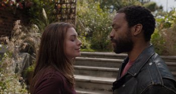 Movie still from “Locked Down” (2021), directed by Doug Liman – A man and a woman standing next to each other; Close Up shot, Over the shoulder angle