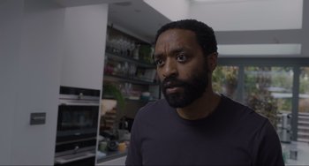 Movie still from “Locked Down” (2021), directed by Doug Liman – A person with a beard in a room; Close Up shot, Low angle