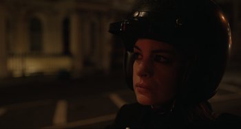Movie still from “Locked Down” (2021), directed by Doug Liman – A woman wearing a motorcycle helmet in the dark; Close Up shot, Over the shoulder angle