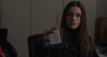 Movie still from “Locked Down” (2021), directed by Doug Liman – A woman is holding up her id card; Close Up shot, Over the shoulder angle