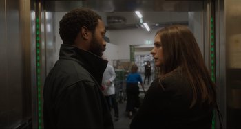 Movie still from “Locked Down” (2021), directed by Doug Liman – A man and a woman are talking in a room; Medium shot, Over the shoulder angle