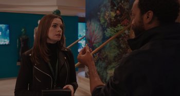 Movie still from “Locked Down” (2021), directed by Doug Liman – A woman in a black jacket talking to a man in a black jacket; Medium shot, Over the shoulder angle