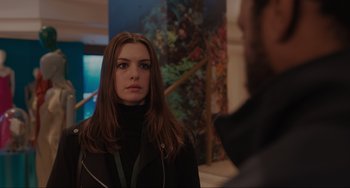 Movie still from “Locked Down” (2021), directed by Doug Liman – A beautiful woman standing next to a man in front of a painting; Close Up shot, Over the shoulder angle