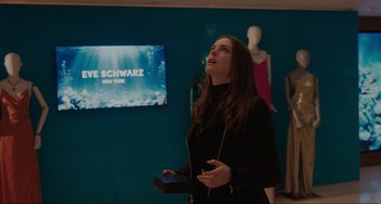 Movie still from “Locked Down” (2021), directed by Doug Liman – A woman holding a wii controller in front of a television; Medium shot, Over the shoulder angle