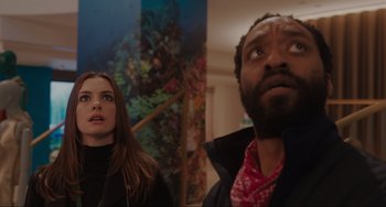 Movie still from “Locked Down” (2021), directed by Doug Liman – A man and a woman standing next to each other in a room; Close Up shot, Low angle