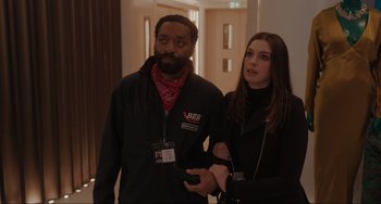 Movie still from “Locked Down” (2021), directed by Doug Liman – A man and a woman standing next to each other; Medium shot, Over the shoulder angle