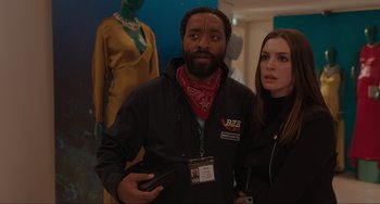 Movie still from “Locked Down” (2021), directed by Doug Liman – A man and a woman standing next to each other in front of mannequins; Medium shot, Over the shoulder angle