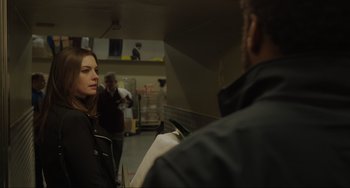 Movie still from “Locked Down” (2021), directed by Doug Liman – A woman standing next to a man in a building; Close Up shot, Over the shoulder angle