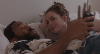 Movie still from “Locked Down” (2021), directed by Doug Liman – A man and a woman laying in a bed; Close Up shot, Over the shoulder angle