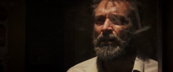 Movie still from “Logan” (2017), directed by James Mangold – A man with a gray beard is looking at the camera; Close Up shot, Over the shoulder angle