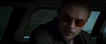 Movie still from “Logan” (2017), directed by James Mangold – A person wearing sunglasses in a car; Close Up shot, Over the shoulder angle