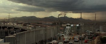 Movie still from “Logan” (2017), directed by James Mangold – A group of people standing on the side of a road; Extreme Wide shot, Low angle