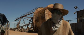 Movie still from “Logan” (2017), directed by James Mangold – A man wearing a cowboy hat and a scarf; Wide shot, Low angle