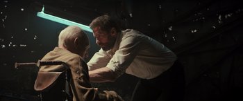 Movie still from “Logan” (2017), directed by James Mangold – A man with a bald head and a beard is holding onto a bald headed man; Medium shot, Low angle