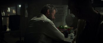 Movie still from “Logan” (2017), directed by James Mangold – A man sitting at a table with a bowl of fruit; Close Up shot, Over the shoulder angle