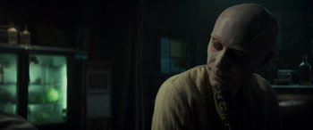 Movie still from “Logan” (2017), directed by James Mangold – A man with a bald head is looking at the camera; Close Up shot, Over the shoulder angle
