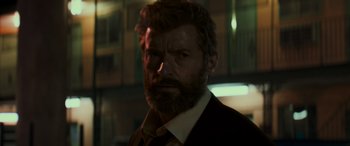 Movie still from “Logan” (2017), directed by James Mangold – A person wearing a suit and tie; Close Up shot, Low angle