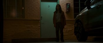 Movie still from “Logan” (2017), directed by James Mangold – A woman standing in front of a door way; Wide shot, Low angle