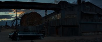 Movie still from “Logan” (2017), directed by James Mangold – A car parked in front of an industrial building at night; Extreme Wide shot, Low angle
