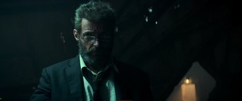 Movie still from “Logan” (2017), directed by James Mangold – A person wearing a suit and tie; Close Up shot, Low angle