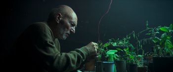 Movie still from “Logan” (2017), directed by James Mangold – An older man is working on a plant; Close Up shot, Low angle