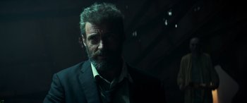 Movie still from “Logan” (2017), directed by James Mangold – A person wearing a suit and tie; Close Up shot, Low angle