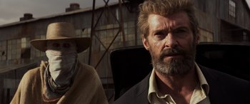 Movie still from “Logan” (2017), directed by James Mangold – A man sitting next to another man in a chair; Close Up shot, Low angle