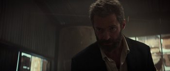 Movie still from “Logan” (2017), directed by James Mangold – A person wearing a suit and tie; Close Up shot, Low angle