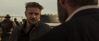 Movie still from “Logan” (2017), directed by James Mangold – A man with a beard is talking to another man in front of a car; Close Up shot, Over the shoulder angle