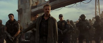 Movie still from “Logan” (2017), directed by James Mangold – A group of men standing next to each other on top of a bridge; Medium shot, Low angle