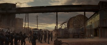 Movie still from “Logan” (2017), directed by James Mangold – A group of people standing in a dirt field; Extreme Wide shot, Low angle