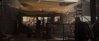 Movie still from “Logan” (2017), directed by James Mangold – A person standing in a room with a lot of windows; Wide shot, Low angle