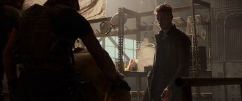 Movie still from “Logan” (2017), directed by James Mangold – A man standing next to another man in a room; Medium shot, Over the shoulder angle