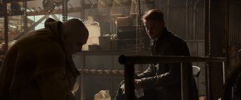 Movie still from “Logan” (2017), directed by James Mangold – A man sitting next to another man in a room; Medium shot, Over the shoulder angle