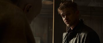 Movie still from “Logan” (2017), directed by James Mangold – A man looking into a mirror while standing next to another man; Close Up shot, Over the shoulder angle