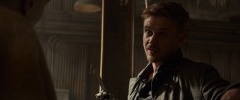 Movie still from “Logan” (2017), directed by James Mangold – A person holding a knife in a room; Close Up shot, Over the shoulder angle