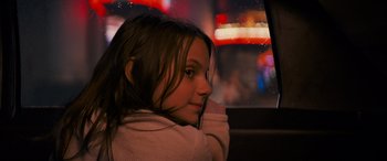 Movie still from “Logan” (2017), directed by James Mangold – A young girl sitting in the back seat of a car; Close Up shot, Over the shoulder angle