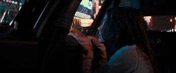 Movie still from “Logan” (2017), directed by James Mangold – A woman sitting in a car looking out the window at night; Close Up shot, Low angle