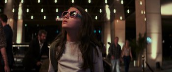 Movie still from “Logan” (2017), directed by James Mangold – A young girl wearing sunglasses looking up at the sky; Close Up shot, Low angle