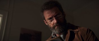 Movie still from “Logan” (2017), directed by James Mangold – A man with a beard and glasses looking at a piece of paper; Close Up shot, Low angle