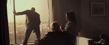 Movie still from “Logan” (2017), directed by James Mangold – A man and a woman sitting in front of a window; Wide shot, Low angle