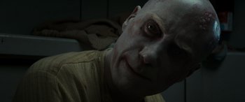 Movie still from “Logan” (2017), directed by James Mangold – A man with a bald head is looking at the camera; Close Up shot, Over the shoulder angle