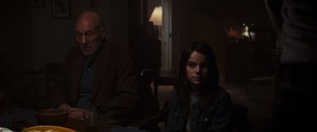 Movie still from “Logan” (2017), directed by James Mangold – A woman sitting in front of an older man in a room; Medium shot, Over the shoulder angle