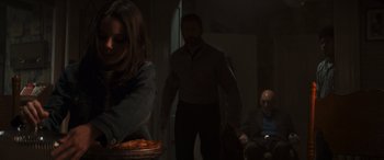 Movie still from “Logan” (2017), directed by James Mangold – A man and a woman in a dark room; Medium shot, Over the shoulder angle