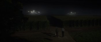 Movie still from “Logan” (2017), directed by James Mangold – Two men walking on a dirt road at night; Extreme Wide shot, High angle