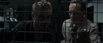 Movie still from “Logan” (2017), directed by James Mangold – Two men are in a cage looking at each other; Close Up shot, Over the shoulder angle