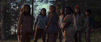 Movie still from “Logan” (2017), directed by James Mangold – A group of people standing in the grass; Medium shot, Low angle