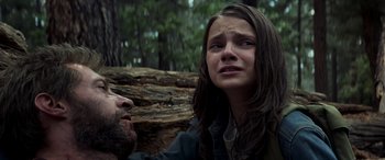 Movie still from “Logan” (2017), directed by James Mangold – A woman and a man in the woods looking at each other; Close Up shot, Low angle