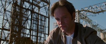 Movie still from “Looper” (2012), directed by Rian Johnson – A person wearing a jacket; Close Up shot, Low angle